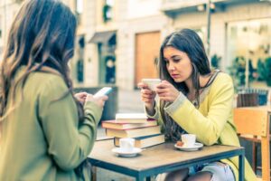 Women with smartphones in a bar