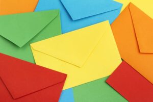 An array of bright and colorful envelopes in five colors