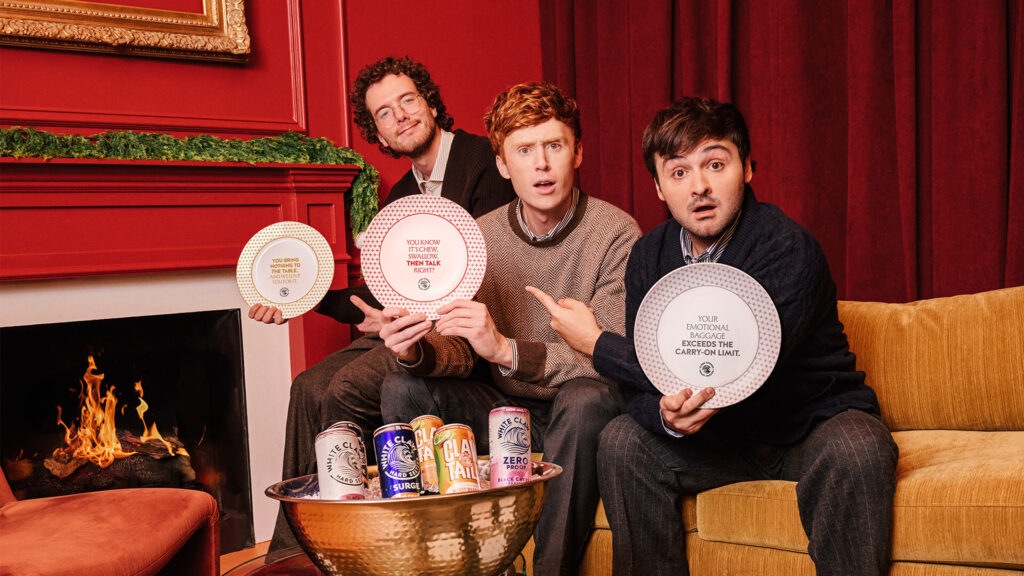 Hard seltzer beverage brand White Claw hired comedy trio Please Don’t Destroy for its holiday campaign centered on roasting friends and hosting merchandise.